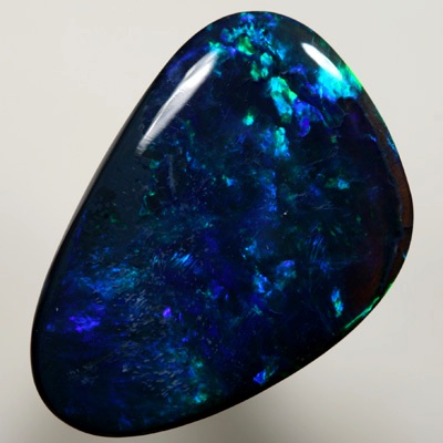 SOLID BLACK OPAL Gem quality opal. Bright strong peacock fire in a Flame pattern SEE VIDEO